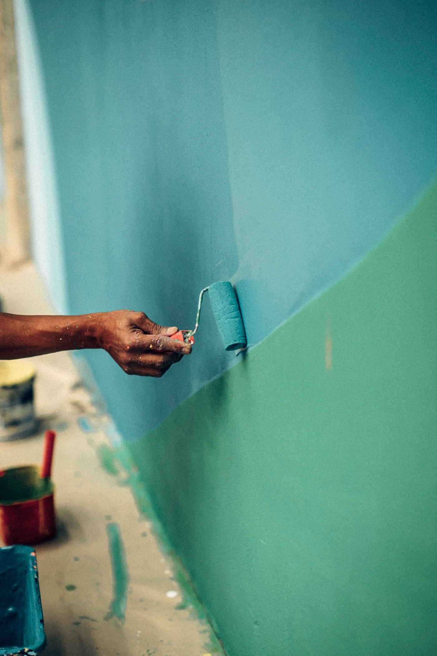 Painting a green interior wall with a roller